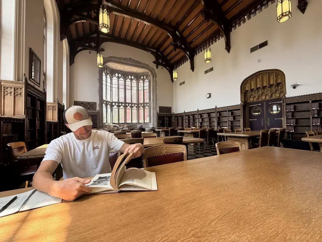 Derik Keith reviewing historical records in an archive reading room